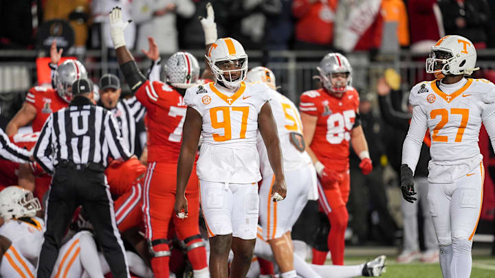 Tennessee defensive lineman Jayson Jenkins (97) and Tennessee defensive lineman James Pearce Jr. (27) walk off after Ohio State scores a touchdown in the final minutes of the third quarter during a College Football Playoff first round game between Tennessee and Ohio State held at Ohio Stadium in Columbus, Ohio, on Saturday, Dec. 21, 2024.