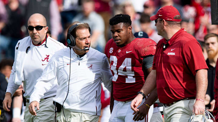 Alabama head coach Nick Saban walks with running back Damien Harris (34) after he was injured against The Citadel in second half action at Bryant-Denny Stadium in Tuscaloosa, Ala., on Saturday November 17, 2018