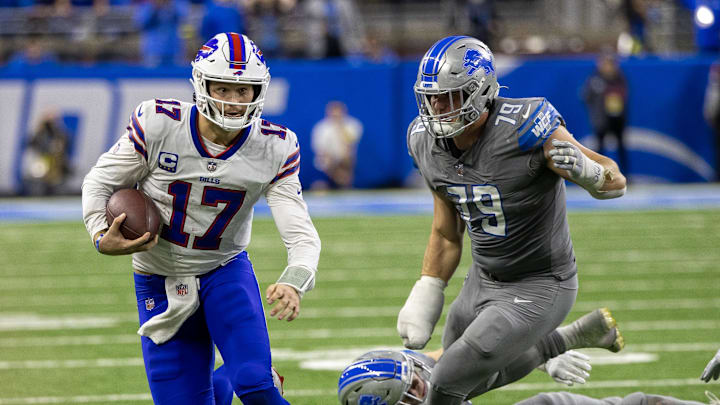 Nov 24, 2022; Detroit, Michigan, USA; Buffalo Bills quarterback Josh Allen (17) runs past Detroit Lions defensive end John Cominsky (79) during the second half at Ford Field.