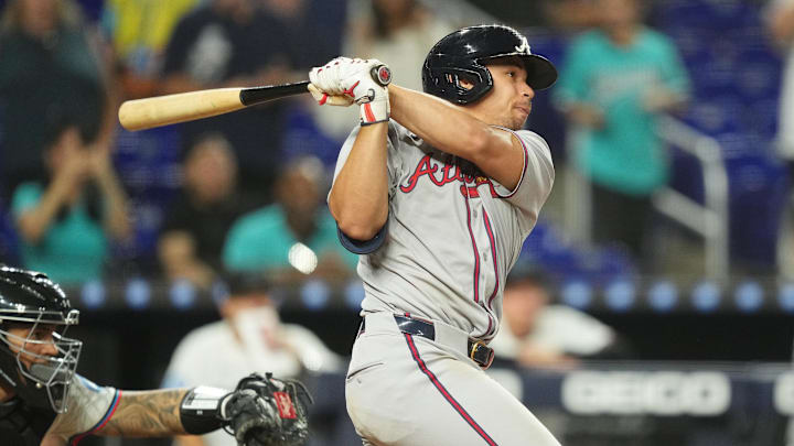 A Cubs pitcher has flown past him A Cubs pitcher has flown past him