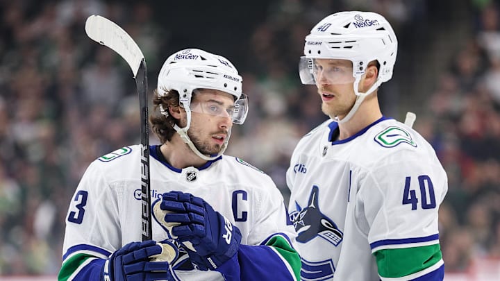 Dec 3, 2024; Saint Paul, Minnesota, USA;Vancouver Canucks defenseman Quinn Hughes (43) and center Elias Pettersson (40) talk before a power play against the Minnesota Wild during the first period at Xcel Energy Center. Mandatory Credit: Matt Krohn-Imagn Images