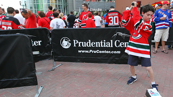 May 25, 2012; Newark, NJ, USA; A young fan hits a New York Rangers logo before game six of the 2012 Eastern Conference Finals at the Prudential Center.  Mandatory Credit: Ed Mulholland-Imagn Images