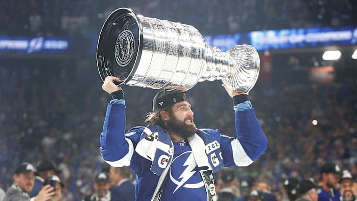Jul 7, 2021; Tampa, Florida, USA; Tampa Bay Lightning left wing Pat Maroon (14) hoists the Stanley Cup after the Lightning defeated the Montreal Canadiens 1-0 in game five to win the 2021 Stanley Cup Final at Amalie Arena. Mandatory Credit: Kim Klement-Imagn Images