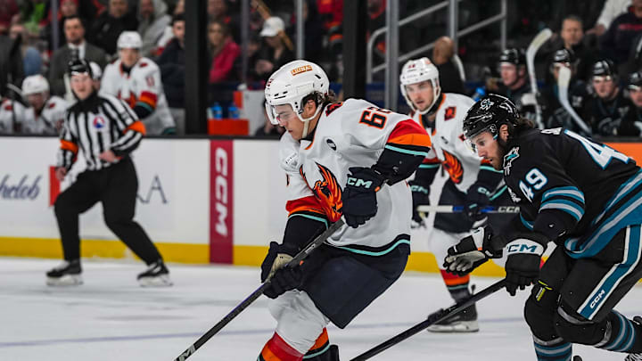 Coachella Valley forward Tucker Robertson tries to work his way around San Jose forward Scott Sabourin to open up a shot during the first period of their game at Acrisure Arena in Palm Desert, Calif., Thursday, Dec. 12, 2024.