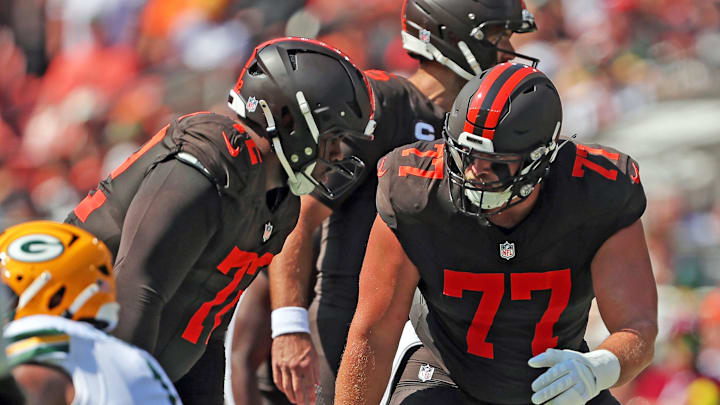 Cleveland Browns guard Wyatt Teller (77) has a word with offensive tackle KT Leveston (72) before a play during the first half of an NFL football game at Huntington Bank Field, Sept. 21, 2025, in Cleveland, Ohio.