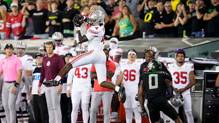 Oct 12, 2024; Eugene, Oregon, USA; Ohio State Buckeyes wide receiver Jeremiah Smith (4) makes a catch against Oregon Ducks defensive back Tysheem Johnson (0) in the second half during the NCAA football game at Autzen Stadium.