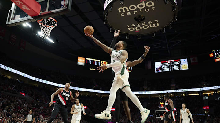 Jan 31, 2024; Portland, Oregon, USA; Milwaukee Bucks guard Damian Lillard (0) scores a basket during the first half against Portland Trail Blazers center Deandre Ayton (2) at Moda Center. Mandatory Credit: Troy Wayrynen-Imagn Images Jan 31, 2024; Portland, Oregon, USA; Milwaukee Bucks guard Damian Lillard (0) scores a basket during the first half against Portland Trail Blazers center Deandre Ayton (2) at Moda Center. Mandatory Credit: Troy Wayrynen-Imagn Images