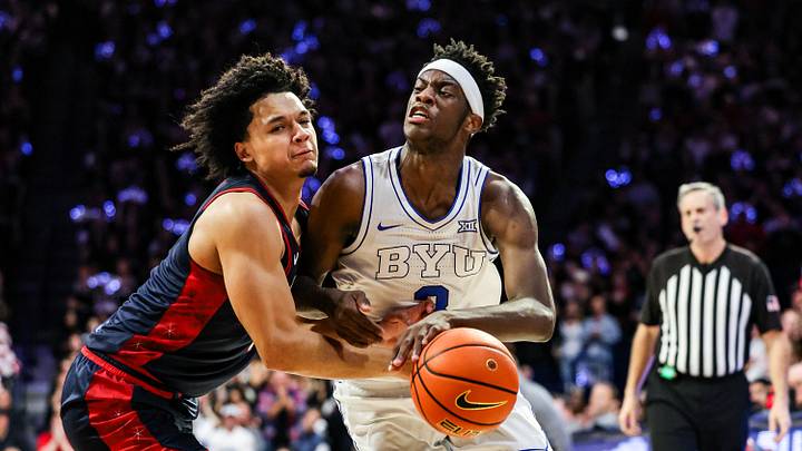 Feb 18, 2026; Tucson, Arizona, USA; Brigham Young Cougars forward AJ Dybantsa (3) dribbles the ball while Arizona Wildcats guard Brayden Burries (5) attempts to block him during the first half of the game at McKale Memorial Center. Mandatory Credit: Aryanna Frank-Imagn Images