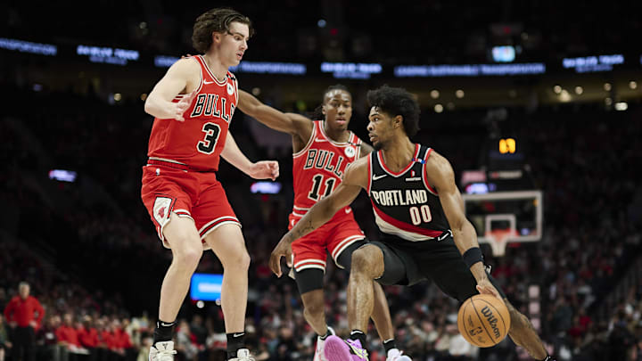 Jan 19, 2025; Portland, Oregon, USA; Portland Trail Blazers guard Scoot Henderson (00) drives past Chicago Bulls guard Josh Giddey (3) and guard Ayo Dosunmu (11) during the second half at Moda Center. Mandatory Credit: Troy Wayrynen-Imagn Images