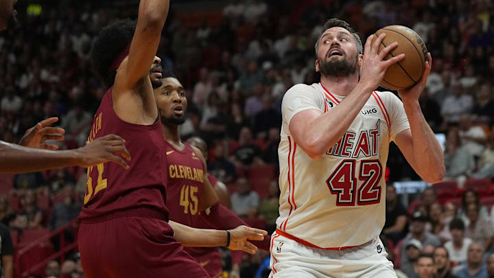 Mar 10, 2023; Miami, Florida, USA;  Miami Heat forward Kevin Love (42) grabs a rebound as Cleveland Cavaliers center Jarrett Allen (31) defends in the first half at Miami-Dade Arena. Mandatory Credit: Jim Rassol-Imagn Images
