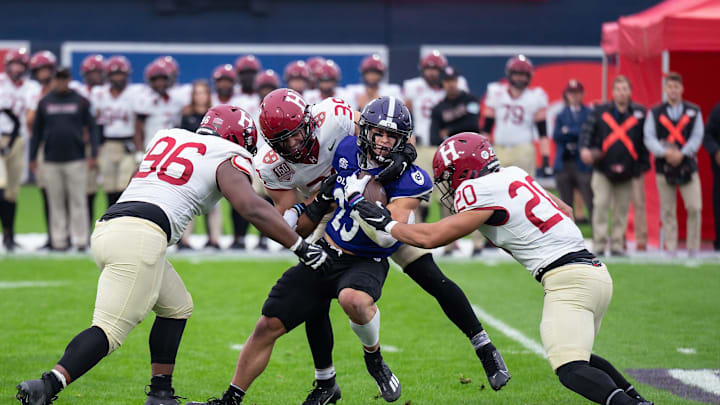 Holy Cross's Jordan Fuller is tackled by a wall of Harvard defenders during Saturday's EBW Football Classic at Polar Park.