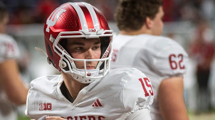 Indiana's Fernando Mendoza (15) gets loose before the Indiana versus Ohio State Big Ten Championship football game at Lucas Oil Stadium on Saturday, Dec. 6, 2025.