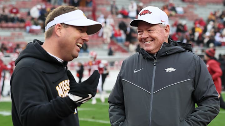 Fayetteville, Arkansas, USA; Arkansas Razorbacks interim head coach Bobby Petrino talks to Missouri Tigers head coach Eli Drinkwitz prior to a game against the at Donald W. Reynolds Razorback Stadium.