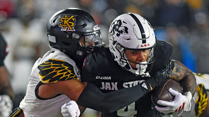 Jax State's Cam Cook tries to evade the tackle of Kennesaw State's Alexander Ford during the C-USA Championship at AmFirst Stadium in Jacksonville, Alabama December 5, 2025. (Dave Hyatt / Hyatt Media LLC)