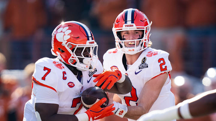 Clemson Tigers quarterback Cade Klubnik hands the ball off to running back Phil Mafah.