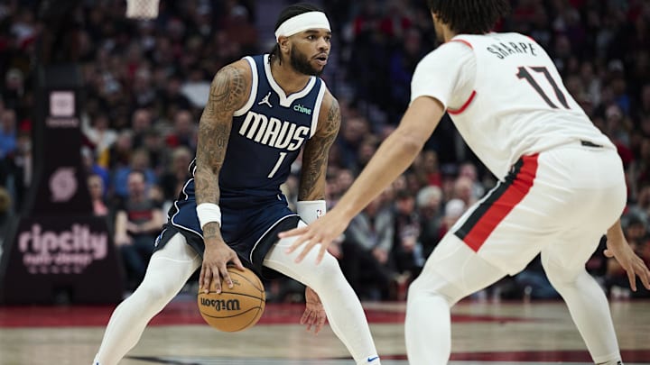 Dec 28, 2024; Portland, Oregon, USA; Dallas Mavericks guard Jaden Hardy (1) dribbles the basketball during the first half against Portland Trail Blazers guard Shaedon Sharpe (17) at Moda Center. Mandatory Credit: Troy Wayrynen-Imagn Images