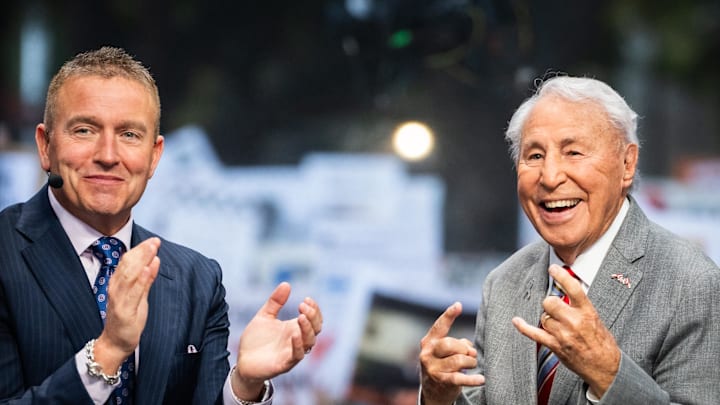 Oct 19, 2024; Austin, Texas, USA; ESPN analysts Kirk Herbstreit (left) and Lee Corso get ready to begin ESPN College Game Day, at the University of Texas on the South Mall, before a game between the Texas Longhorns and the Georgia Bulldogs  at Darrell K Royal-Texas Memorial Stadium. Mandatory Credit: Sara Diggins/USA TODAY Network via Imagn Images