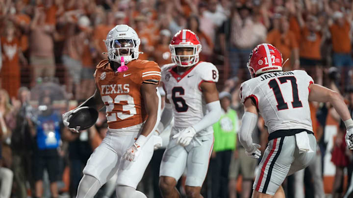 Texas Longhorns running back Jaydon Blue scores a touchdown against Georgia Bulldogs defensive back Daylen Everette, left, and Georgia Bulldogs defensive back Dan Jackson in the third quarter at Darrell K Royal-Texas Memorial Stadium Saturday October 19, 2024. Texas Longhorns running back Jaydon Blue scores a touchdown against Georgia Bulldogs defensive back Daylen Everette, left, and Georgia Bulldogs defensive back Dan Jackson in the third quarter at Darrell K Royal-Texas Memorial Stadium Saturday October 19, 2024.