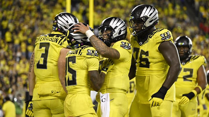 Oct 4, 2024; Eugene, Oregon, USA; Oregon Ducks wide receiver Tez Johnson (15), left, celebrates catching a touchdown pass with Oregon Ducks quarterback Dillon Gabriel (8) during the second half against the Michigan State Spartans at Autzen Stadium.