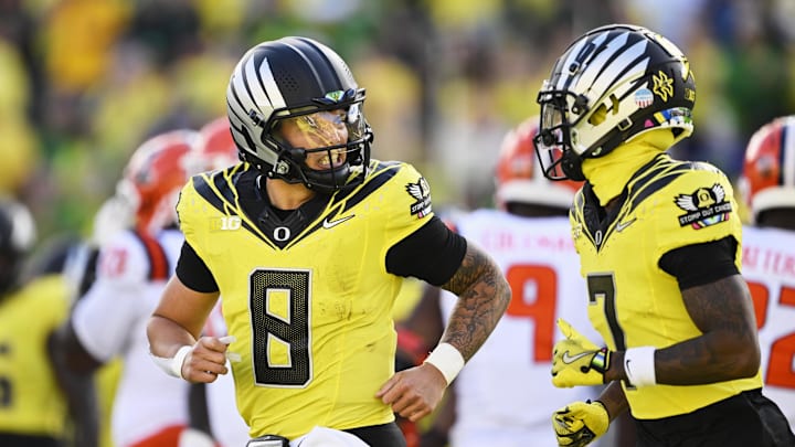 Oct 26, 2024; Eugene, Oregon, USA; Oregon Ducks quarterback Dillon Gabriel (8) celebrates with wide receiver Evan Stewart (7) after scoring a touchdown during the first half against Illinois Fighting Illini at Autzen Stadium. Mandatory Credit: Troy Wayrynen-Imagn Images
