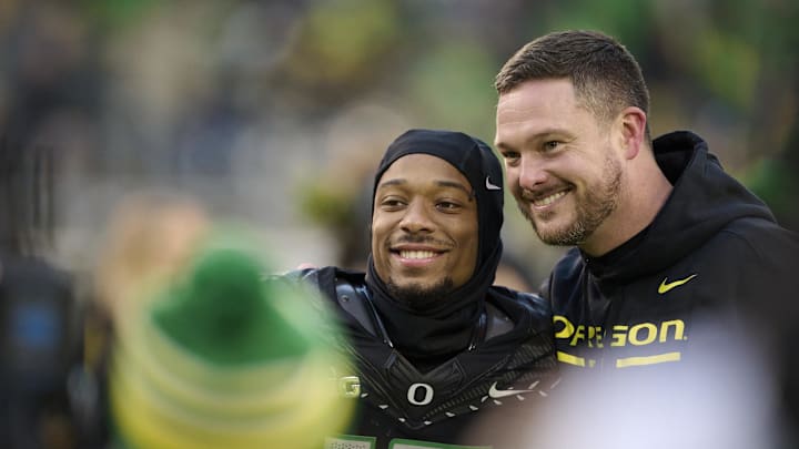 Nov 30, 2024; Eugene, Oregon, USA; Oregon Ducks head coach Dan Lanning celebrates with wide receiver Tez Johnson (15) during a senior recognition ceremony before a game against the Washington Huskies at Autzen Stadium. Nov 30, 2024; Eugene, Oregon, USA; Oregon Ducks head coach Dan Lanning celebrates with wide receiver Tez Johnson (15) during a senior recognition ceremony before a game against the Washington Huskies at Autzen Stadium.