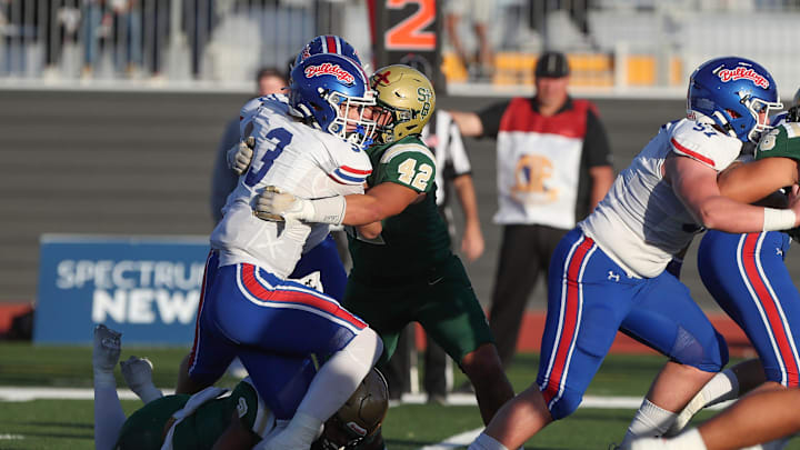 Folsom quarterback Ryder Lyons is stopped by St. Bonaventure's Ben Meza during the first quarter of the CIF-State Division 1-A state championship bowl at Saddleback College in Mission Viejo on Saturday, Dec. 9, 2023. St. Bonaventure lost 20-14.
