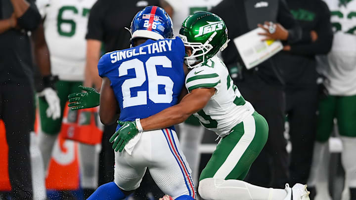 New York Jets cornerback Michael Carter II (30) tackles New York Giants running back Devin Singletary (26).