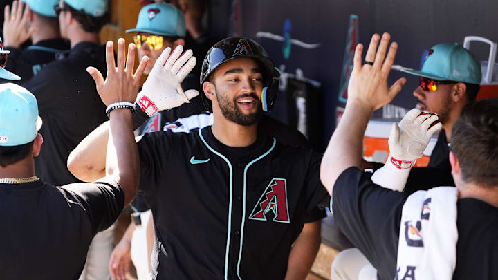 Arizona Diamondbacks Jordan Lawlar receives high-fives in the dugout after hitting a two-run home run off Milwaukee Brewers pitcher Tyler Alexander in the second inning of a spring training game at Salt River Fields at Talking Stick on Feb. 26, 2025.