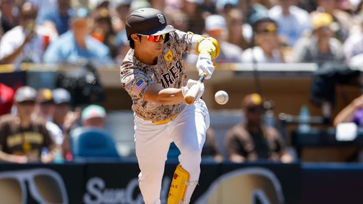 Aug 4, 2024; San Diego, California, USA;  San Diego Padres shortstop Ha-Seong Kim (7) hits a sacrifice bunt during the second inning against the Colorado Rockies at Petco Park.