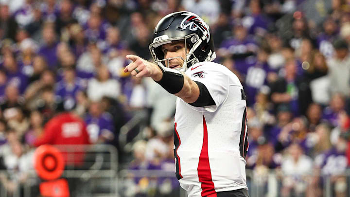 Dec 8, 2024; Minneapolis, Minnesota, USA; Atlanta Falcons quarterback Kirk Cousins (18) celebrates running back Bijan Robinson's (7) touchdown against the Minnesota Vikings during the third quarter at U.S. Bank Stadium.  