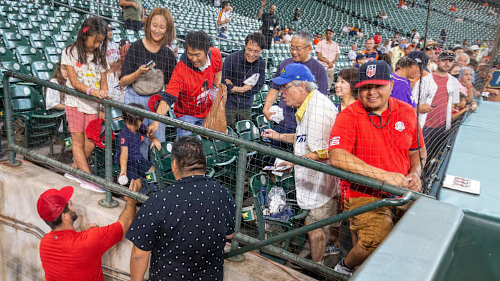 Angels relief pitcher Jose Quijada (65) signs autographs for fans before playing against the Houston Astros at Minute Maid Park on Sept. 9, 2022.