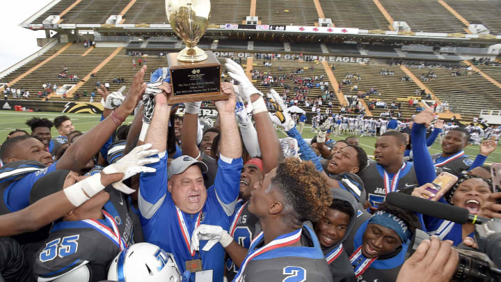 The Jefferson Davis County Jaguars and head coach Lance Mancuso celebrate with the Class 3A trophy at the MHSAA State Football Championship at M.M. Roberts Stadium on the University of Southern Mississippi campus in Hattiesburg on Friday, Dec. 6, 2019. The Jefferson Davis County Jaguars and head coach Lance Mancuso celebrate with the Class 3A trophy at the MHSAA State Football Championship at M.M. Roberts Stadium on the University of Southern Mississippi campus in Hattiesburg on Friday, Dec. 6, 2019.