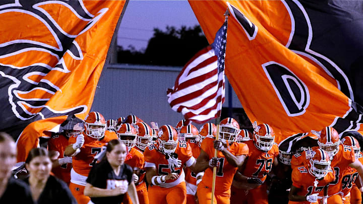Blackman's Ethan Carson (1) carries an American flag onto the field as they players run onto the field before the start of the football game against Oakland at Blackman, on Friday, Sept. 20, 2024. The TSSAA and the Rutherford County Sheriff's Office are both investigating an alleged pepper spray incident that took place during the game.