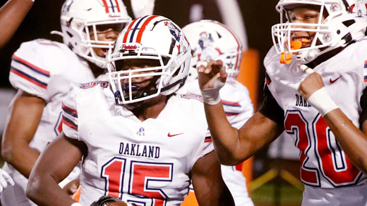Oakland's Justin Barber (15) celebrates recovering a fumble made by Blackman as Oakland's Ethan Burrell (20) also celebrates the fumble during a football game at Blackman, on Friday, Sept. 20, 2024.