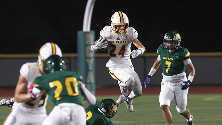 Simi Valley's Evan Rodriguez leaps over Royal's Jonathan Arreola during the second quarter of their rivalry game at Royal High on Friday, Sept. 6, 2024. The Pioneers won 62-10 to reach 3-0 on the season.