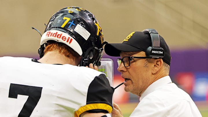 Bishop Garrigan head coach Marty Wadle talks with quarterback Tate Foertsch during the playoffs last year. The Golden Bears are back once again this year in the final four. Bishop Garrigan head coach Marty Wadle talks with quarterback Tate Foertsch during the playoffs last year. The Golden Bears are back once again this year in the final four.