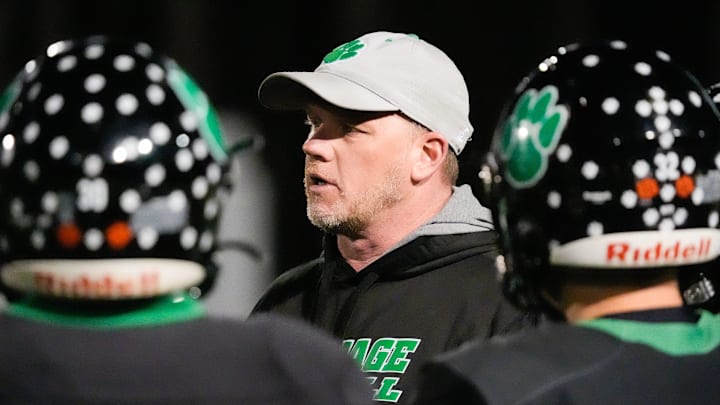 Mountain Heritage head coach Joey Robinson talks to his players during a timeout as his team plays North Stokes HS at home on Friday, November 15, 2024