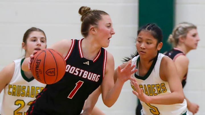 Oostburg’s Riley Ketterhagen (1) drives the ball around Sheboygan Lutheran’s Megan Walz (5) at Lutheran, Tuesday, January 7, 2025, in Sheboygan, Wis. Ketterhagen's 29 point performance against Waunakee leads Oostburg into the top 15.