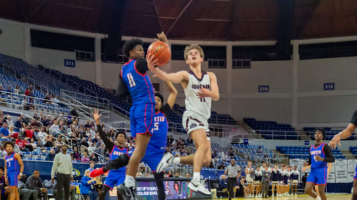 John Luke Bourque (in white) made the winning basket in the semifinals for St. Thomas More.