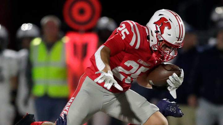 Kimberly High School's Marcus Doucette (25) leaps over Appleton North High School's Jabari Hammond (13) during their football game in Kimberly, Wis. on Friday, October 18, 2024. 