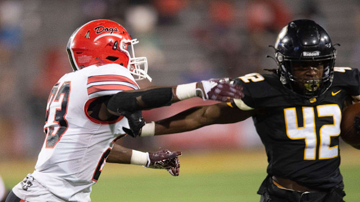 Starkville running back Courtland Cooper (42) stiff arms Brandon linebacker Khalil Norwood (23) during the MHSAA 6A State Championship Gridiron Classic at M.M. Roberts Stadium at the University of Southern Mississippi in Hattiesburg, Miss., Saturday, Dec. 3, 2022.