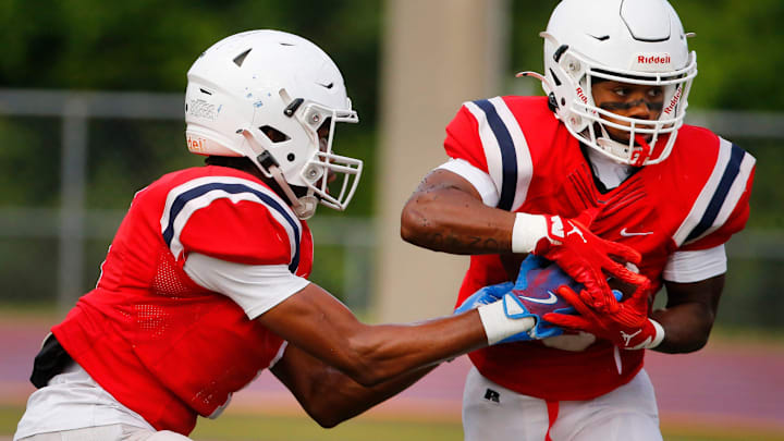 Oakland’s Craig Tutt (1) hands the ball off to Oakland’s Deontae Short (15) during a preseason football scrimmage between Oakland and McCallie at Oakland, on Friday, Aug. 8, 2025.