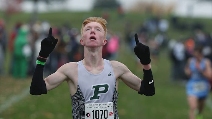 Pella's Canaan Dunham celebrates after finishing his race during the class 3A boys race in the High School Cross Country Championship on Saturday, Oct. 28, 2023, in Fort Dodge, Iowa.