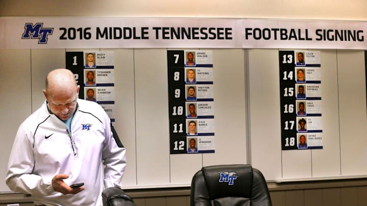 MTSU head football Coach Rick Stockstill looks at his phone, in the football conference room, in front of a wall where new MTSU signees have been added as their paperwork arrives to the office, on Wednesday, Feb. 3, 2016, National Signing Day.

636691704512119581-71-MTSU-Coach-Rick-Stockstill.JPG