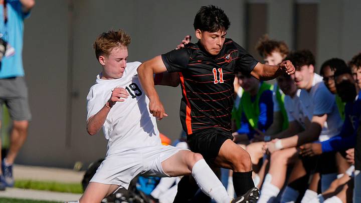 Ames' mid-fielder Joel Martinez (11) drives with the ball as Ankeny Centennial' forward/mid-fielder Tate Duax (19) defends during the first half in the high school boys soccer regular season on May 5, 2025, in Ames, Iowa.
