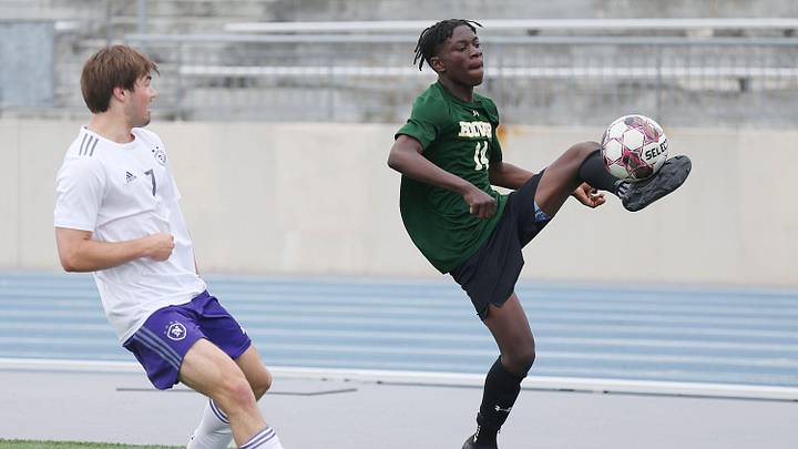 Des Moines Hoover's Janvier Bahati (14) drives with the ball around Norwalk's Keilor Rodman (7) during the first half in the 3A boys state soccer semi-final at Drake Stadium on Friday, May 31,2024, in Des Moines, Iowa,