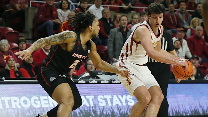 Iowa State Cyclones forward Milan Momcilovic (22) looks for a drive around Houston Cougars forward Joseph Tugler (25)during the first half in the Big-12 conference showdown of an NCAA college basketball at Hilton Coliseum on Tuesday, Jan. 9, 2024, in Ames, Iowa.