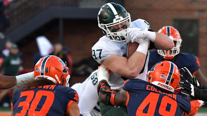 Nov 5, 2022; Champaign, Illinois, USA;  Michigan State Spartans tight end Tyler Hunt (97) is tackled by Illinois Fighting Illini defensive back Sydney Brown (30)  and teammate Seth Coleman (49 )during the second half at Memorial Stadium. Mandatory Credit: Ron Johnson-Imagn Images