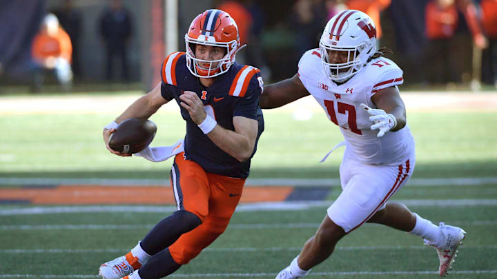 Oct 21, 2023; Champaign, Illinois, USA; Illinois Fighting Illini quarterback Luke Altmyer (9) runs the ball against Wisconsin Badgers linebacker Darryl Peterson (17) during the first half at Memorial Stadium. Mandatory Credit: Ron Johnson-Imagn Images Oct 21, 2023; Champaign, Illinois, USA; Illinois Fighting Illini quarterback Luke Altmyer (9) runs the ball against Wisconsin Badgers linebacker Darryl Peterson (17) during the first half at Memorial Stadium. Mandatory Credit: Ron Johnson-Imagn Images