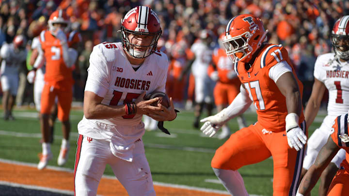 Nov 11, 2023; Champaign, Illinois, USA; Indiana Hoosiers quarterback Brendan Sorsby (15) scores a touchdown during the first half against the Illinois Fighting Illini at Memorial Stadium. Mandatory Credit: Ron Johnson-Imagn Images